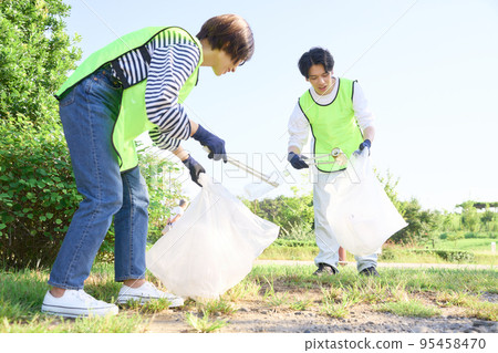 Young men and women picking up trash Volunteer cleaning image Young men and women picking up trash Volunteer cleaning image 95458470