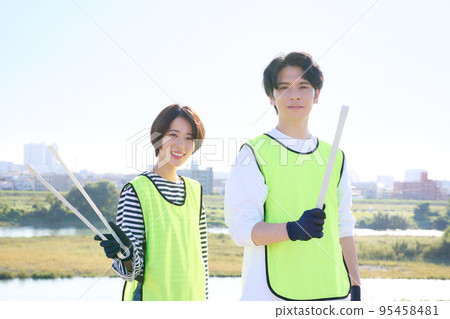 Young men and women picking up trash Volunteer cleaning image Young men and women picking up trash Volunteer cleaning image 95458481