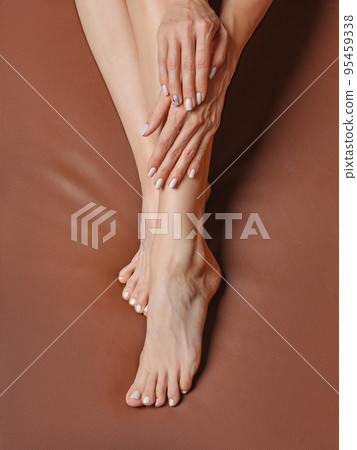 Overhead view of beautiful feet of middle age woman. Concept of taking care for the skin of the feet. 95459338