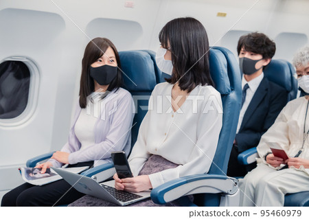 飛機上戴口罩的乘客 飛機上戴口罩的乘客 95460979