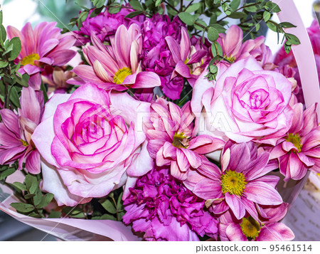 Festive bouquet of garden flowers of pink roses and pyrethrum. Festive bouquet of garden flowers of pink roses and pyrethrum. 95461514