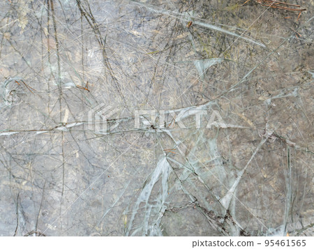 The glass surface is broken into small fragments. 95461565
