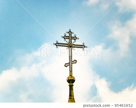 Orthodox church cross on a background of blue sky with clouds. 95461652