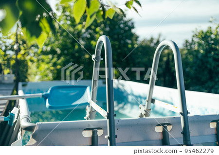Railing stairs down to the pool. Swimming pool entrance in the summer garden at the cottage 95462279