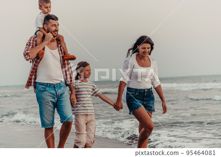 Family gatherings and socializing on the beach at sunset. The family walks along the sandy beach. Selective focus  95464081