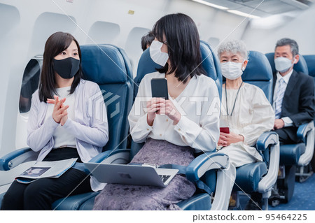 Passengers traveling by plane Passengers traveling by plane 95464225