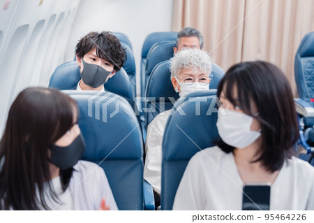 Passengers traveling by plane Passengers traveling by plane 95464226