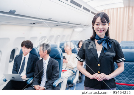 Cabin attendant showing a smile on an airplane 95464235
