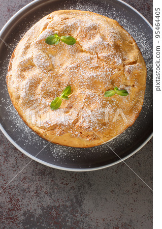 Traditional Polish cake Karpatka of choux pastry dough and custard cream closeup on the plate. Vertical top view 95464405