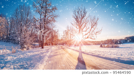 Beautiful view of the sunrise in the morning on the country snowy road. 95464590