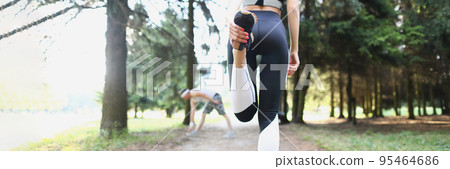 Female stand with back and stretching legs for productive run in forest 95464686