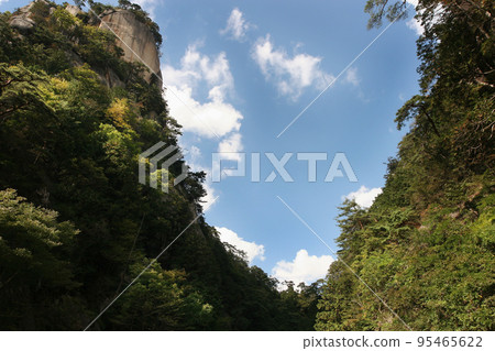 The strength of nature is evident in the way the pine trees take root among the steep, right-angled rocky mountains. The natural formations of Shosenkyo, shining against the blue sky, are a testament to the history of the Earth. The strength of nature is evident in the way the pine trees take root among the steep, right-angled rocky mountains. The natural formations of Shosenkyo, shining against the blue sky, are a testament to the history of the Earth. 95465622