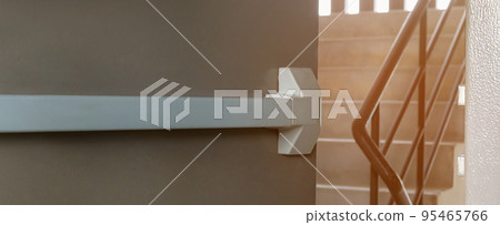 Emergency fire exit door. Closed up latch and rusty door handle of emergency exit. 95465766