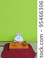 A rabbit relaxing under a kotatsu (vertical) 95466306