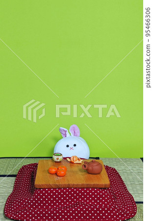 A rabbit relaxing under a kotatsu (vertical) 95466306