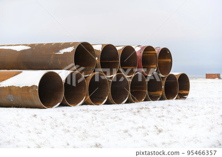 Large tubes in winter tundra. Construction Marine offshore works. Dam building. Large tubes in winter tundra. Construction Marine offshore works. Dam building. 95466357