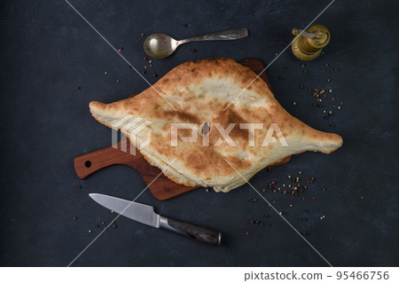 Georgian bread lavash on wooden board on dark rustic background, top view 95466756