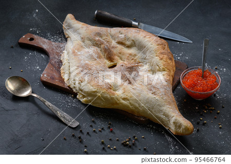 Georgian bread lavash with red caviar on wooden board on dark rustic background, top view Georgian bread lavash with red caviar on wooden board on dark rustic background, top view 95466764
