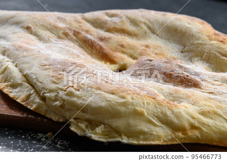 Georgian bread lavash on dark rustic background, close up Georgian bread lavash on dark rustic background, close up 95466773