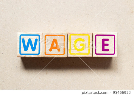 Color letter block in word wage on wood background 95466933