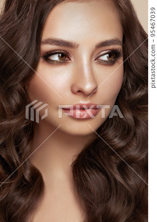 Smiling beautiful woman with long curly hair 95467039