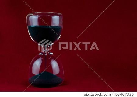 Hourglass Isolated Against a Red Background 95467336