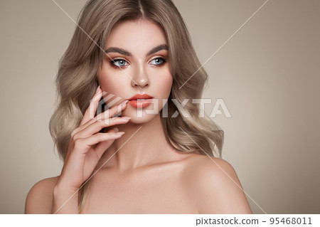 A beautiful young woman with shiny wavy blonde hair A beautiful young woman with shiny wavy blonde hair 95468011
