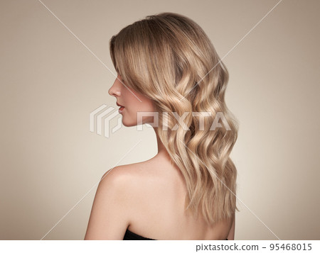 Blonde woman with long curly hair 95468015
