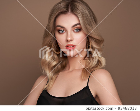 A beautiful young woman with shiny wavy blonde hair A beautiful young woman with shiny wavy blonde hair 95468018