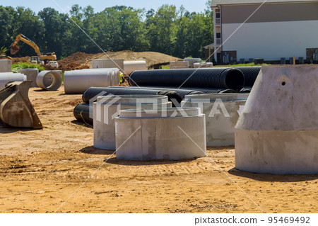 Large section cement sewage concrete well were installed on construction site purpose of creating drainage systems for industrial buildings. 95469492