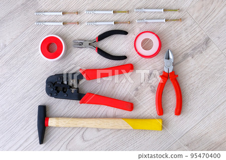 Flat lay of tools, parts, hammer and pliers on white wooden background, close up. Repair in home or apartment with special tools. Diy repairs. Top view. Flat lay of tools, parts, hammer and pliers on white wooden background, close up. Repair in home or apartment with special tools. Diy repairs. Top view. 95470400