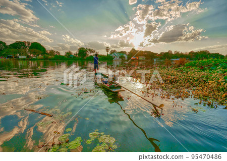 Sunset, River Kwai and rowboat (Khwae Yai River, Kanchanaburi) 95470486