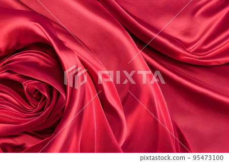 Red Silk Satin Background closeup. Luxury rich background with folded and twirl silk fabric Red Silk Satin Background closeup. Luxury rich background with folded and twirl silk fabric 95473100
