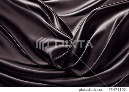 Black Silk Background. Beautiful black satin fabric texture with light wavy folds Black Silk Background. Beautiful black satin fabric texture with light wavy folds 95473102