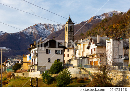 Alpine township of Finero on background of snowy mountains in winter Alpine township of Finero on background of snowy mountains in winter 95473158