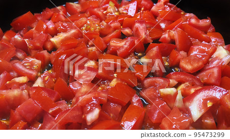 Delicious hot tomato cooked on a frying pan. 95473299