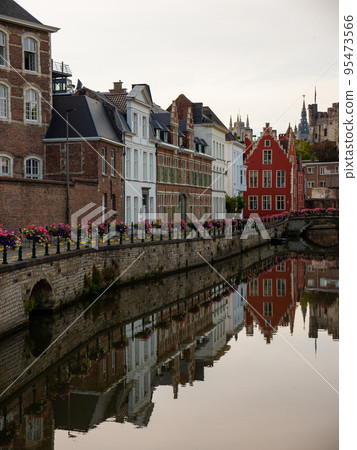 Medieval buildings in historical center of Ghent reflecting in water of river Leie Flanders Medieval buildings in historical center of Ghent reflecting in water of river Leie Flanders 95473566