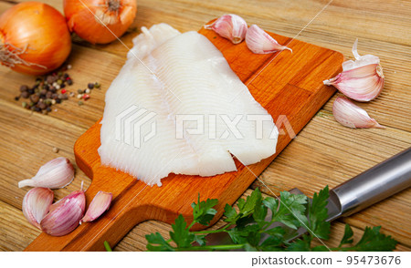 Raw halibut fillet on wooden table Raw halibut fillet on wooden table 95473676