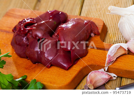 Raw rabbit liver on wooden table Raw rabbit liver on wooden table 95473719