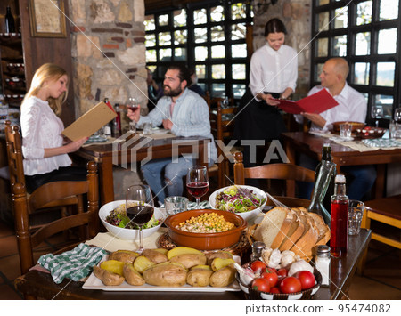 Dining table setting with local specialities 95474082