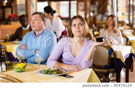 Quarreled visitors female and male at restaurant on celebrate Quarreled visitors female and male at restaurant on celebrate 95474124