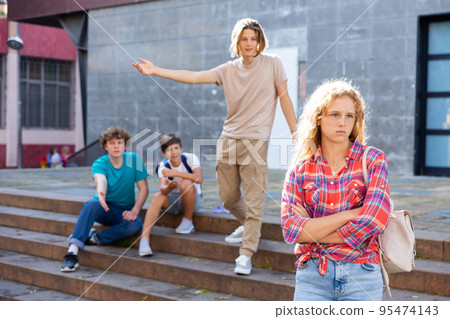 Teenager girl offended by her friends outdoors 95474143