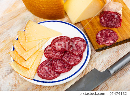 Sliced meat sausage and cheese on plate Sliced meat sausage and cheese on plate 95474182