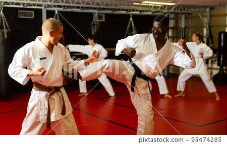 Two men in kimono fighting against each other Two men in kimono fighting against each other 95474285