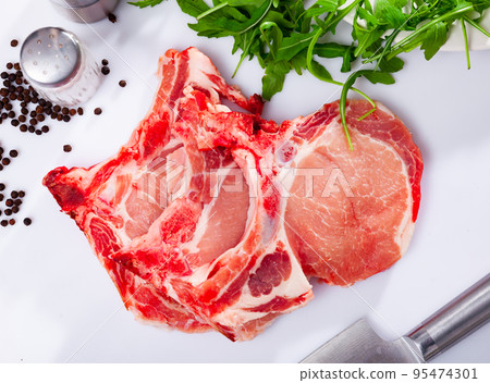 Fresh raw pork loin chops with condiments Fresh raw pork loin chops with condiments 95474301