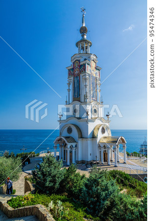 Orthodox Church of St. Nicholas the Wonderworker against the blue sky on the southern coast of Crimea, Malorechenskoye. In honor of the patron saint of sailors and travelers 95474346