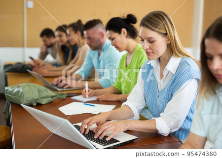 Portrait of a girl student studying on a laptop during class Portrait of a girl student studying on a laptop during class 95474380