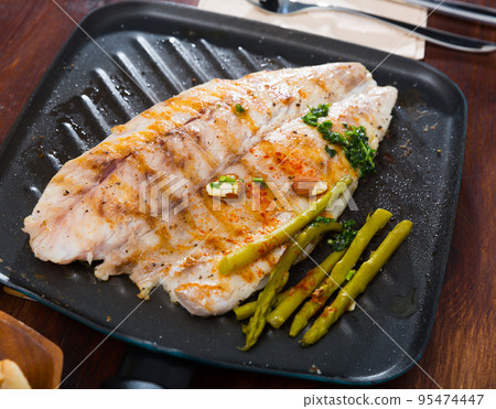 Delicious grilled bass with asparagus 95474447