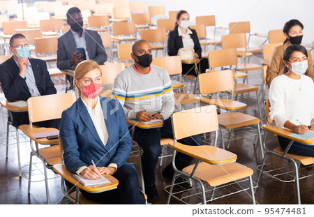 Business people listening to coach at conference 95474481