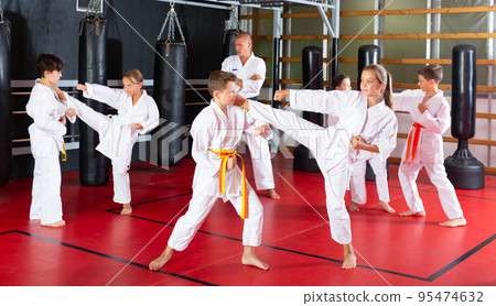 Kids sparring during karate training 95474632
